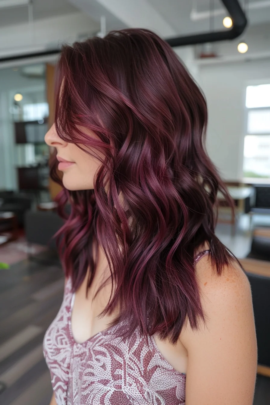 Deep burgundy color melts into lighter raspberry-wine highlights, creating an alluring color variation throughout these medium-length waves. Choppy layers add incredible texture and movement, while the seamless blend of wine-inspired shades creates stunning dimension. Face-framing pieces emphasize the rich, multi-tonal aspects of this bold color choice.