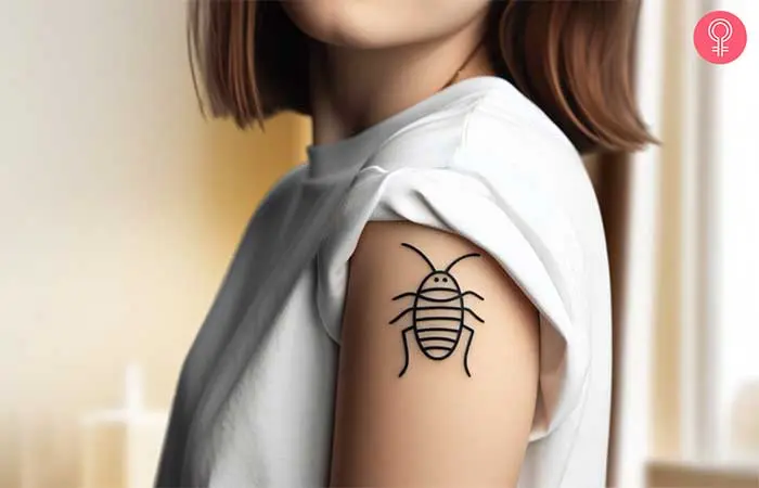 Woman with a lined cockroach tattoo on the upper arm