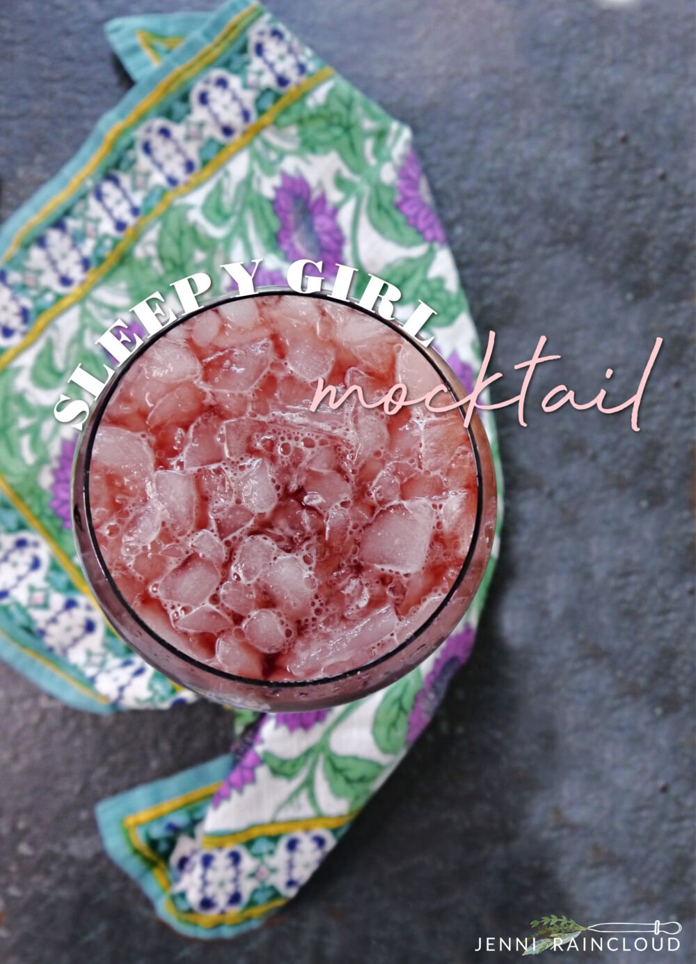 Overhead view of a pink sleep girl mocktail on a napkin. 