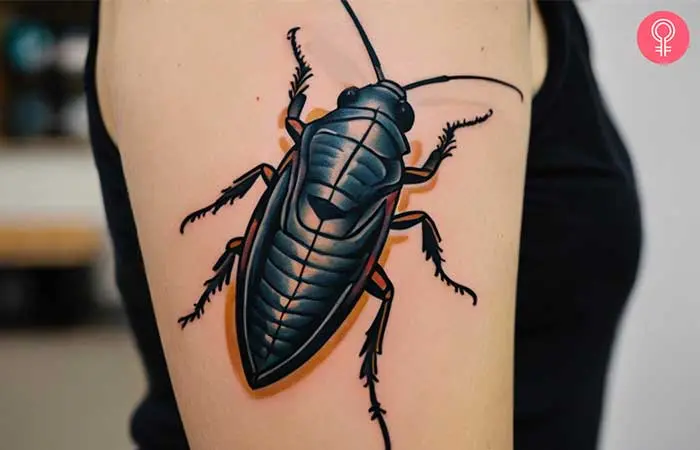 Woman with a traditional cockroach tattoo on the upper arm