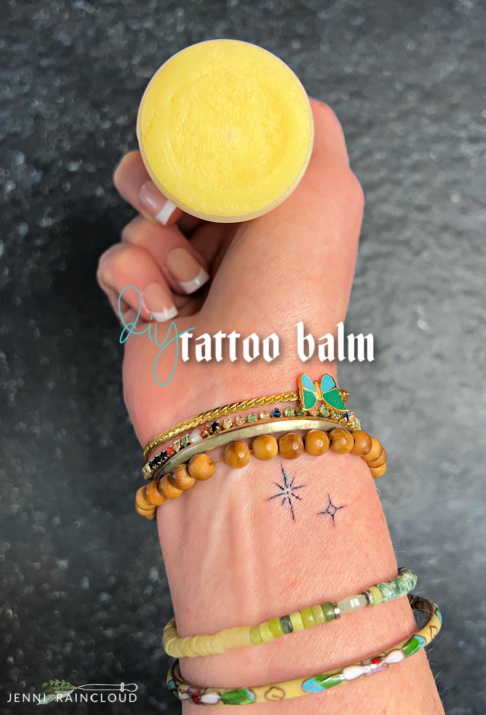 Hand with bracelets holding a DIY tattoo balm.