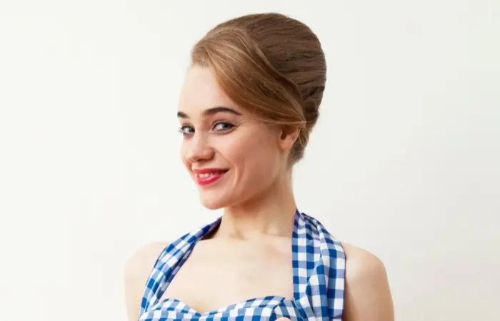 A woman with a beehive updo hairstyle